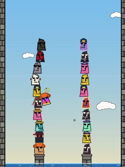 Moai Wanna Stack: two tall towers of colorful moai heads over the sea